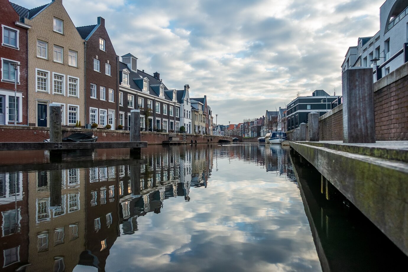 mesmerizing-view-reflection-buildings-river-cloudy-day_181624-22223